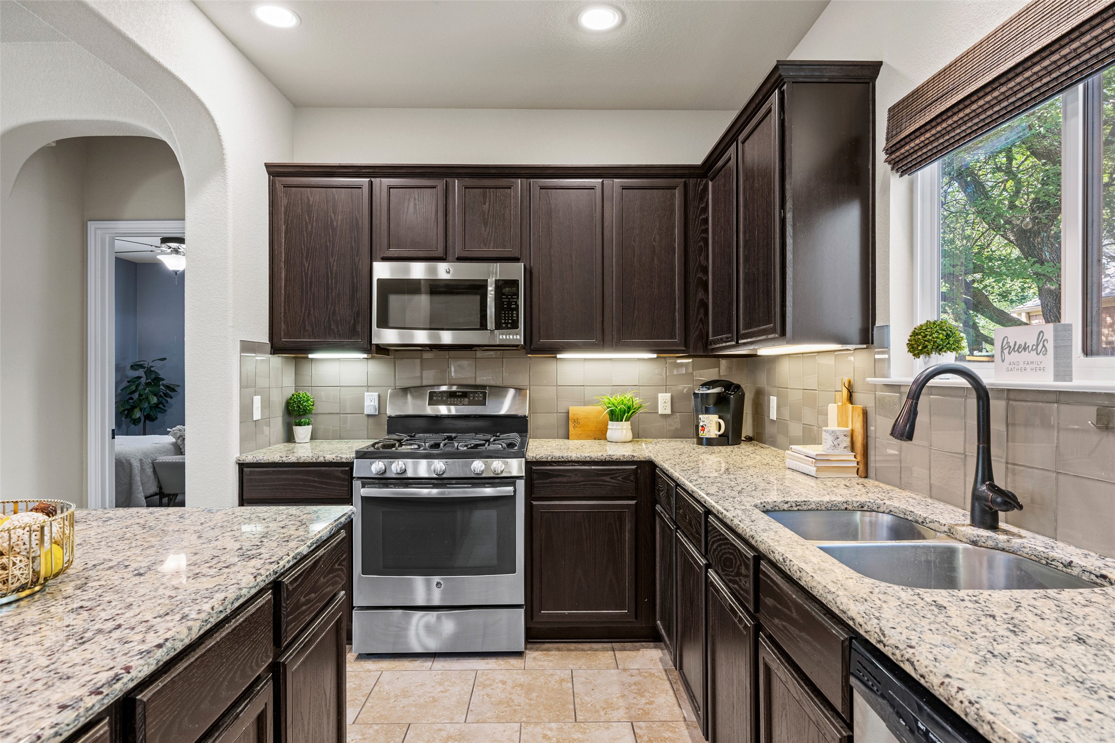 3451 Mayfield Ranch Boulevard, Unit 201 Round Rock, TX 78681 - Photo 8 of 29 a kitchen with granite countertop stainless steel appliances a stove sink and cabinets