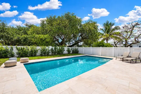 a view of swimming pool with a yard and sitting area