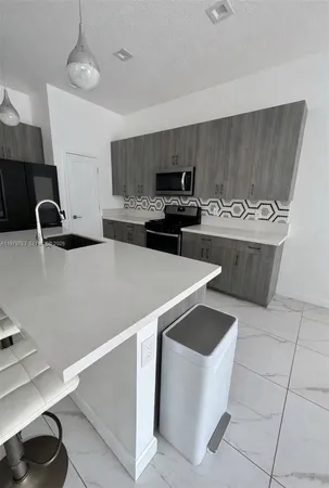 a kitchen with a stove and a sink