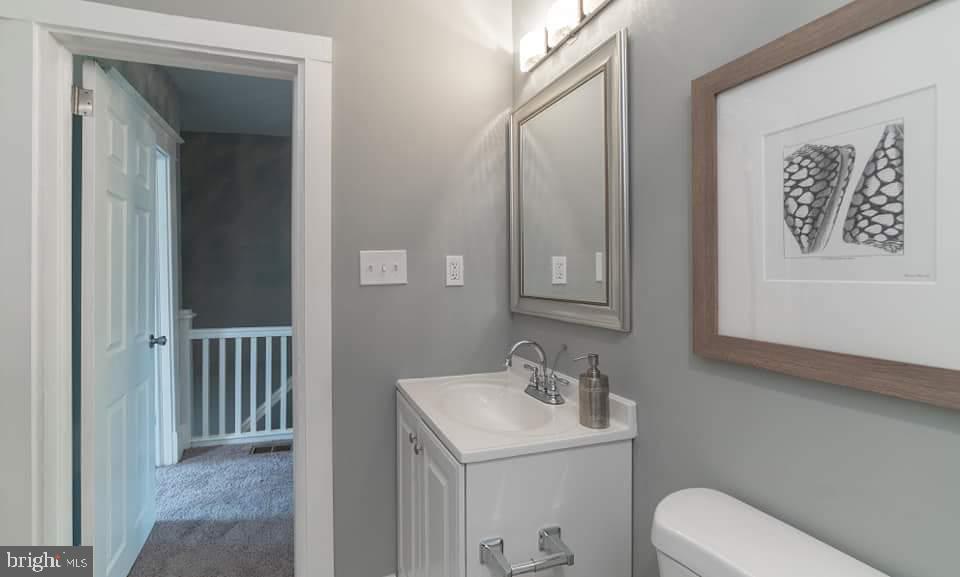 310 Marydell Road Baltimore, MD 21229 - Photo 20 of 26 a bathroom with a toilet sink and mirror