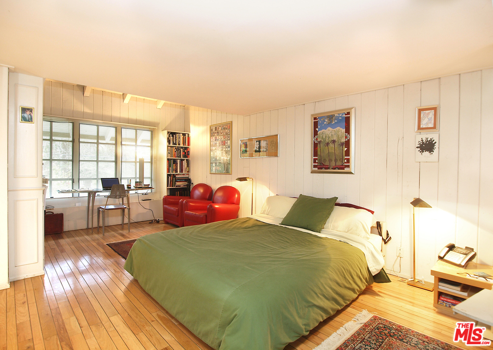507 West Rustic Road Santa Monica, CA 90402 - Photo 16 of 32 a bedroom with a bed and wooden floor