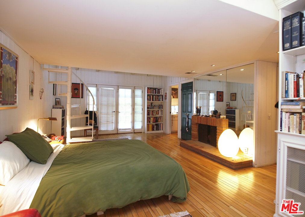 507 West Rustic Road Santa Monica, CA 90402 - Photo 18 of 32 a bedroom with a bed couch and a large window