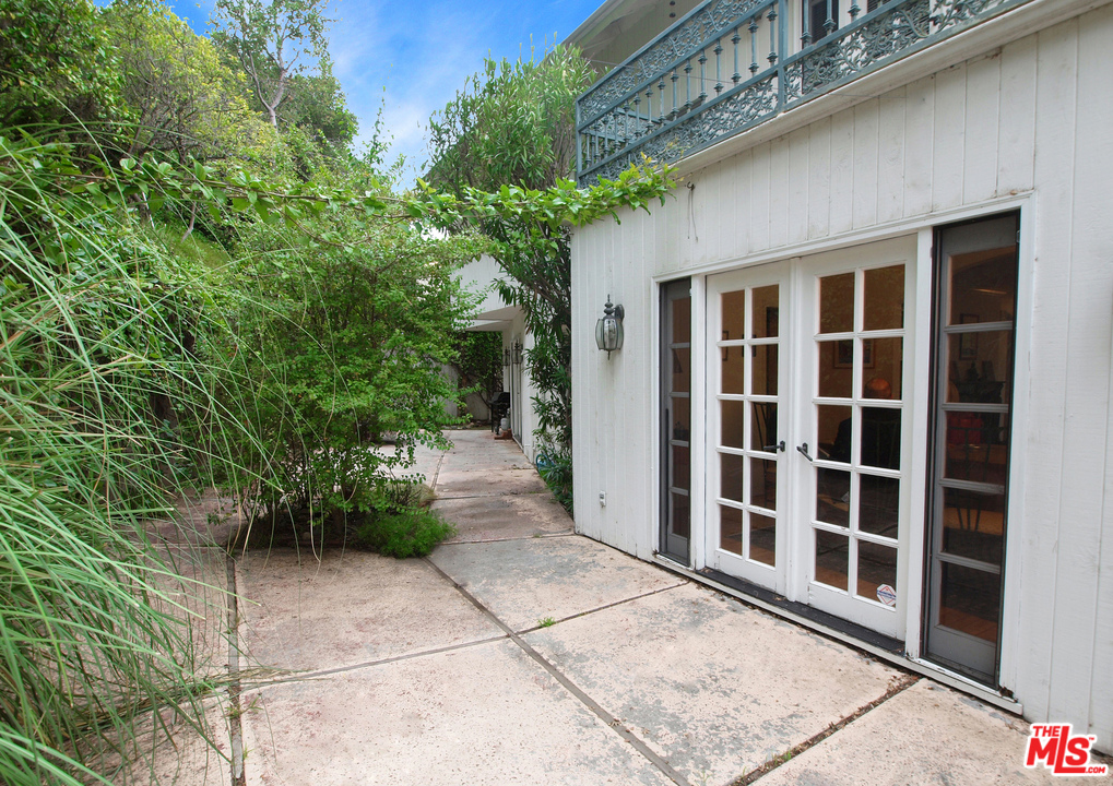 507 West Rustic Road Santa Monica, CA 90402 - Photo 24 of 32 a view of backyard with potted plants and a table and chair