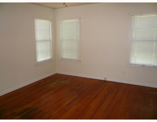 625 Chamberlain Street Corpus Christi, TX 78404 - Photo 7 of 10 an empty room with wooden floor and windows