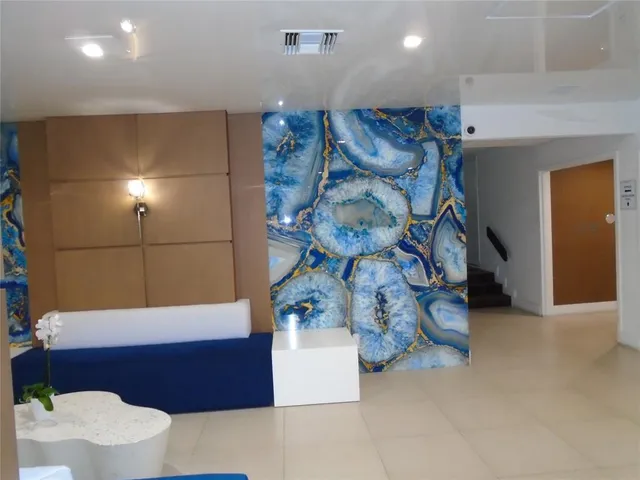 a kitchen with granite countertop white cabinets and black appliances