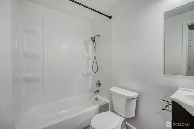 a bathroom with a toilet and a bath tub