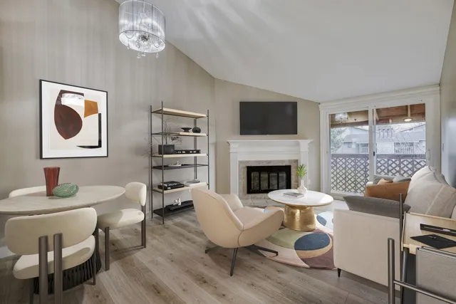 a living room with furniture a fireplace and a flat screen tv