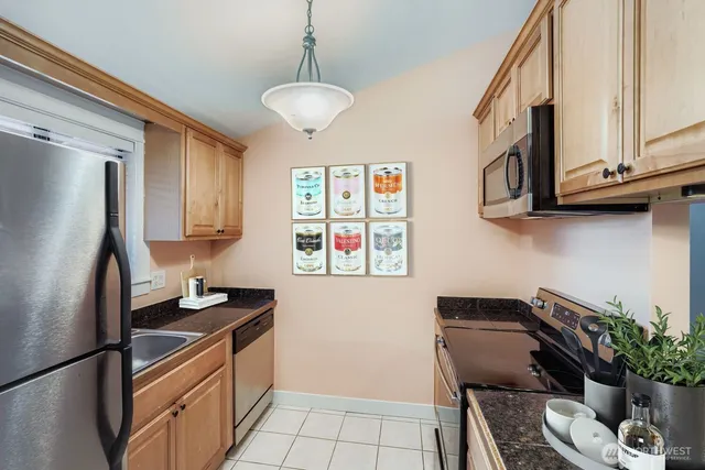a kitchen with stainless steel appliances granite countertop a refrigerator stove and sink