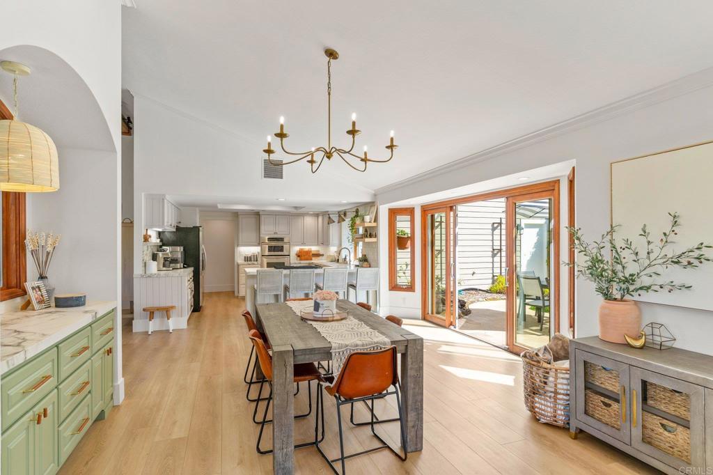 3355 Lone Jack Road Encinitas, CA 92024 - Photo 26 of 54 a view of a dining room with furniture window and wooden floor