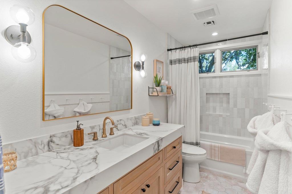 3355 Lone Jack Road Encinitas, CA 92024 - Photo 36 of 54 a bathroom with a granite countertop sink toilet and shower