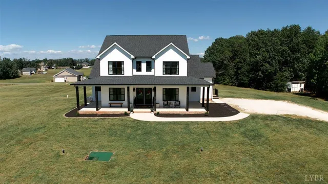 a front view of a house with a yard fire pit and outdoor seating