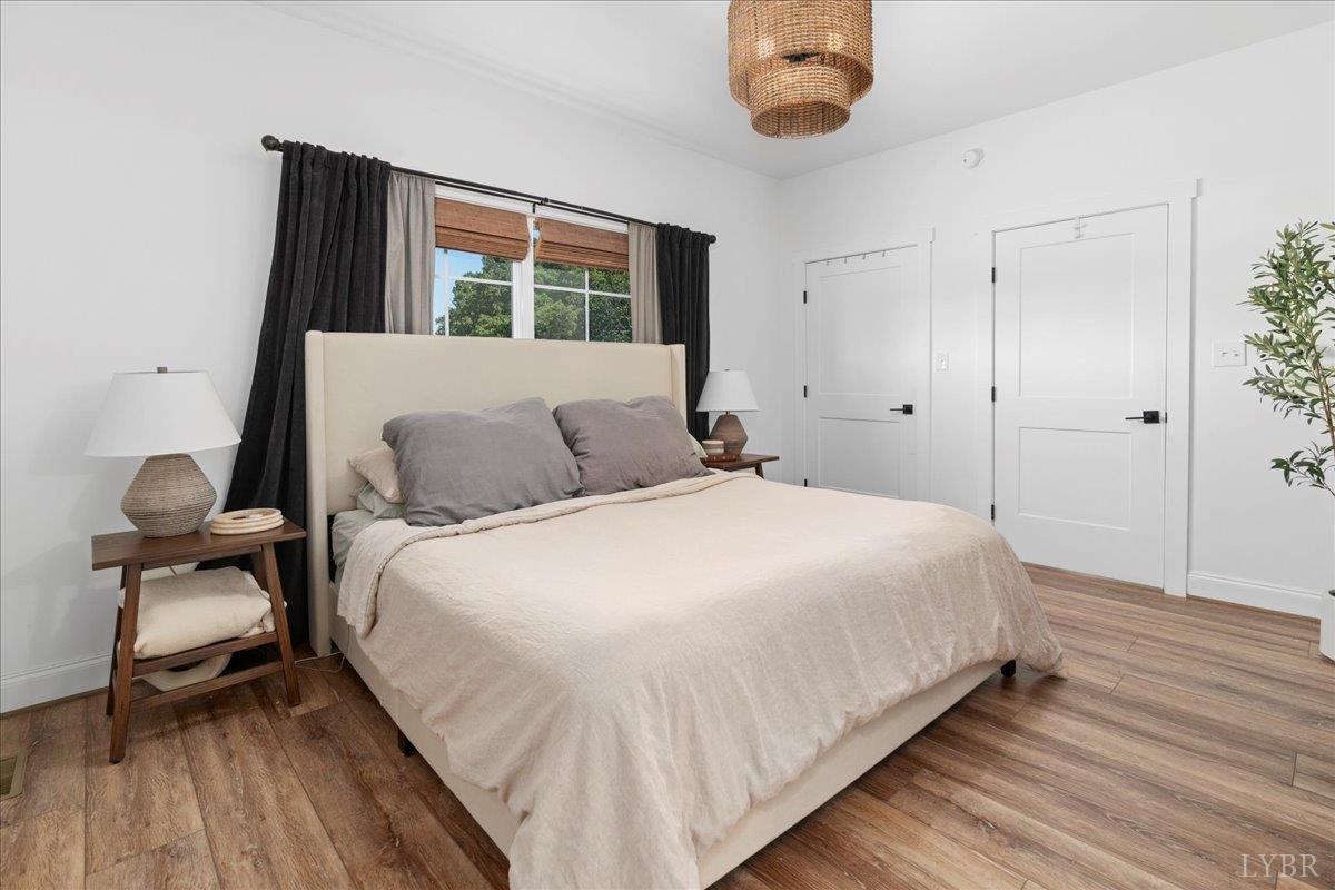 1393 Stonewall Road Concord, VA 24538 - Photo 34 of 85 a bedroom with a bed and a large mirror next to a window