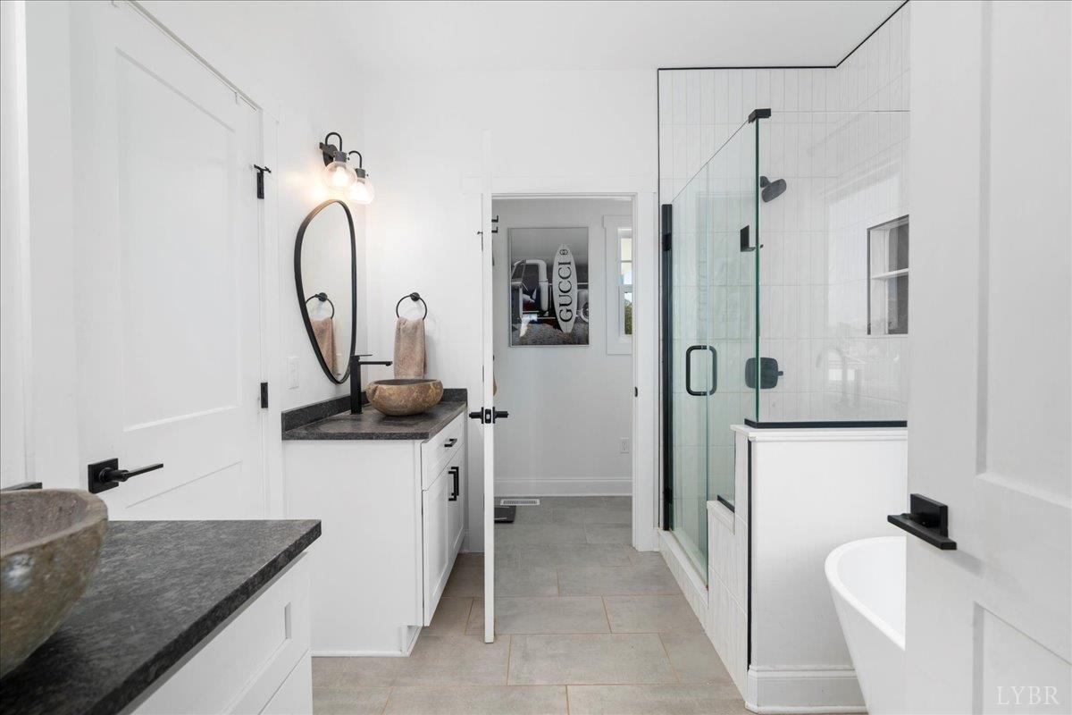 1393 Stonewall Road Concord, VA 24538 - Photo 36 of 85 a bathroom with a granite countertop sink a toilet and a shower