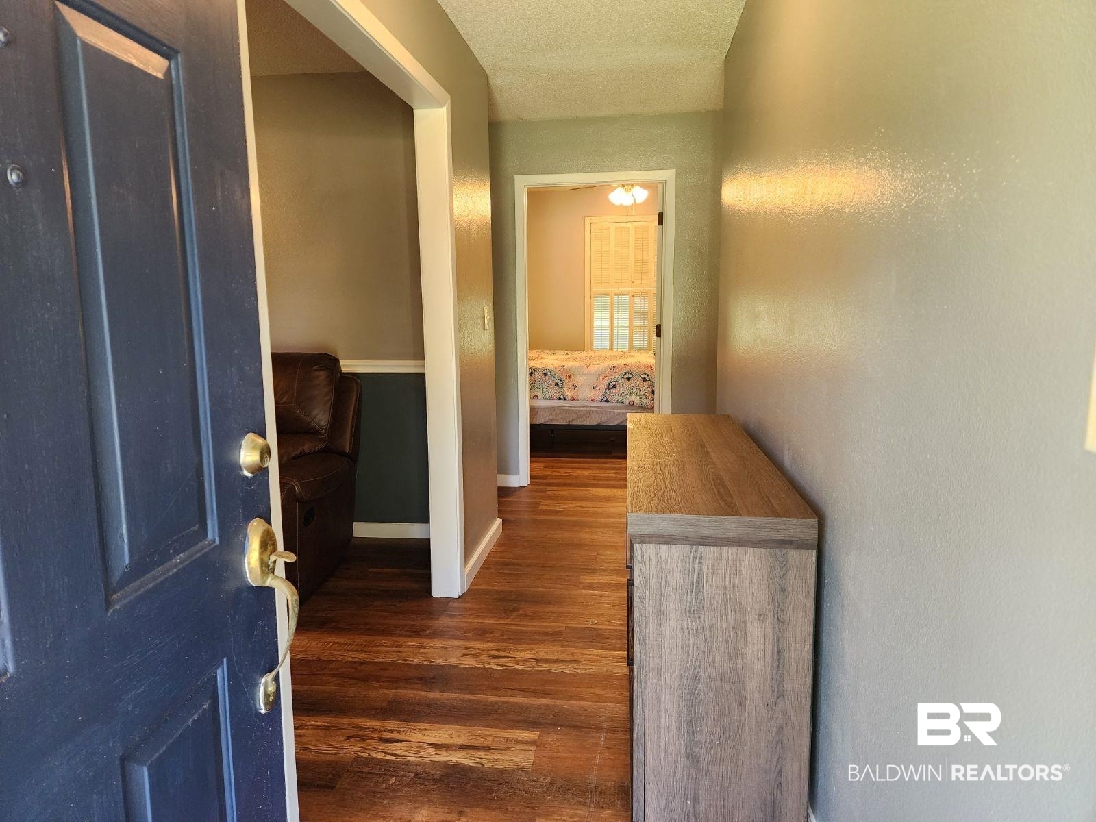 640 Horseshoe Road Brewton, AL 36426 - Photo 6 of 22 Corridor with dark hardwood / wood-style flooring and a textured ceiling