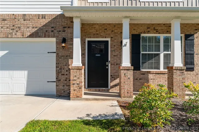 a view of an empty room with a window and fireplace