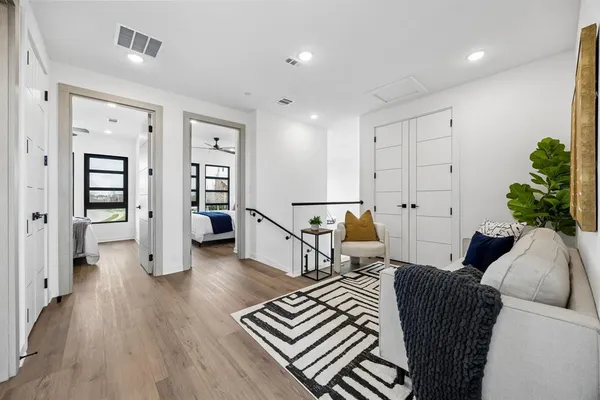 a living room with furniture and wooden floor