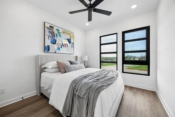 a bedroom with a large bed and a large window