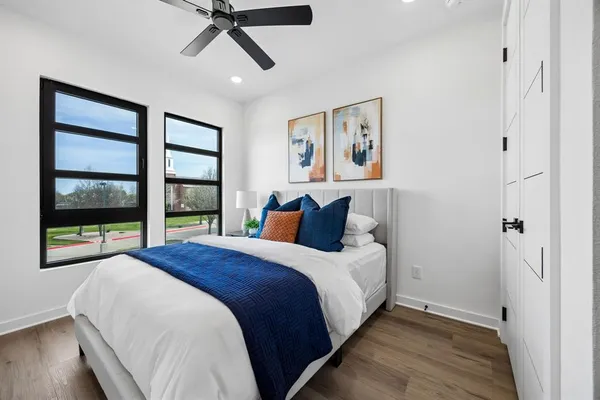 a bed room with a bed and a large window