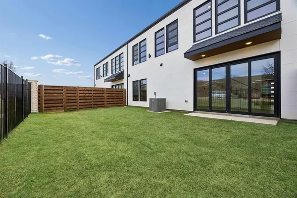 a front view of a building with a garden