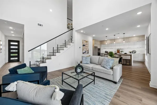 a living room with furniture and wooden floor