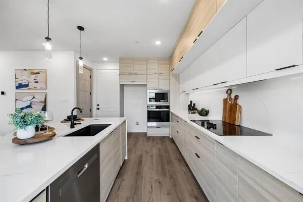 a kitchen with counter top space a sink and cabinets