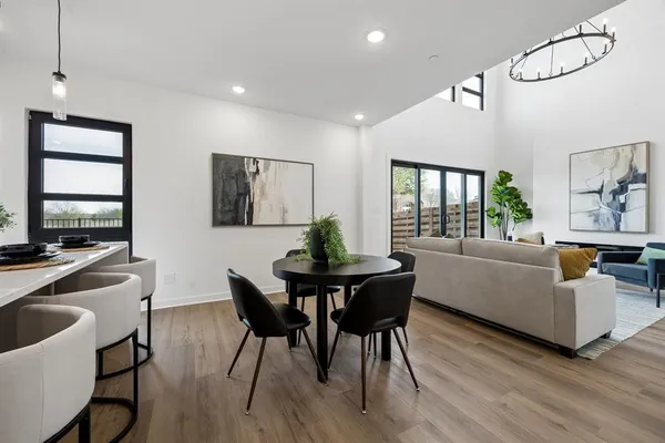 a living room with furniture dining table and a flat screen tv
