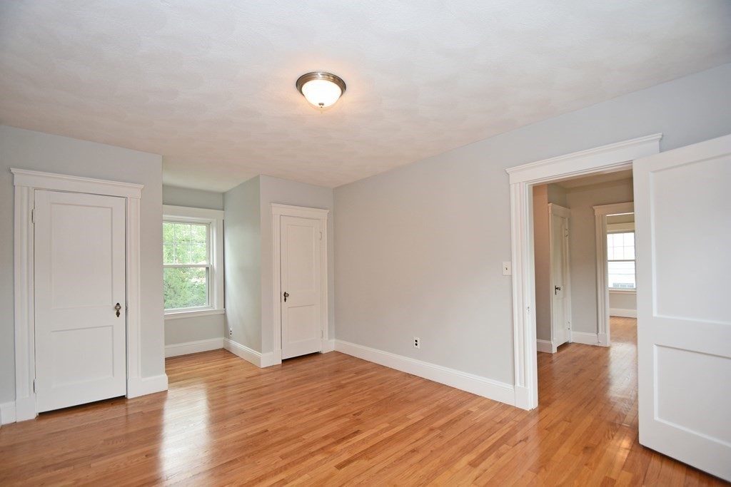 87 Standish Road Watertown, MA 02472 - Photo 13 of 27 an empty room with wooden floor and windows