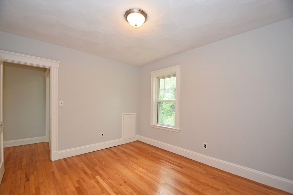 87 Standish Road Watertown, MA 02472 - Photo 17 of 27 an empty room with wooden floor and windows