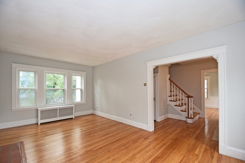 87 Standish Road Watertown, MA 02472 - Photo 3 of 27 wooden floor in an empty room with a window