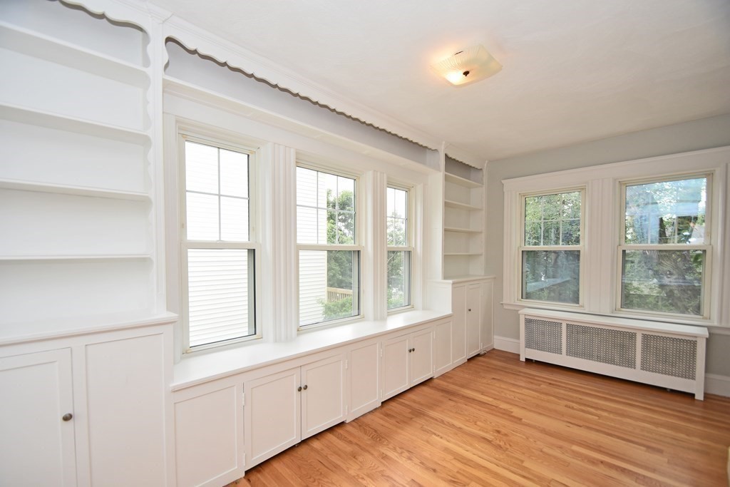 87 Standish Road Watertown, MA 02472 - Photo 6 of 27 a view of an empty room with wooden floor and a window