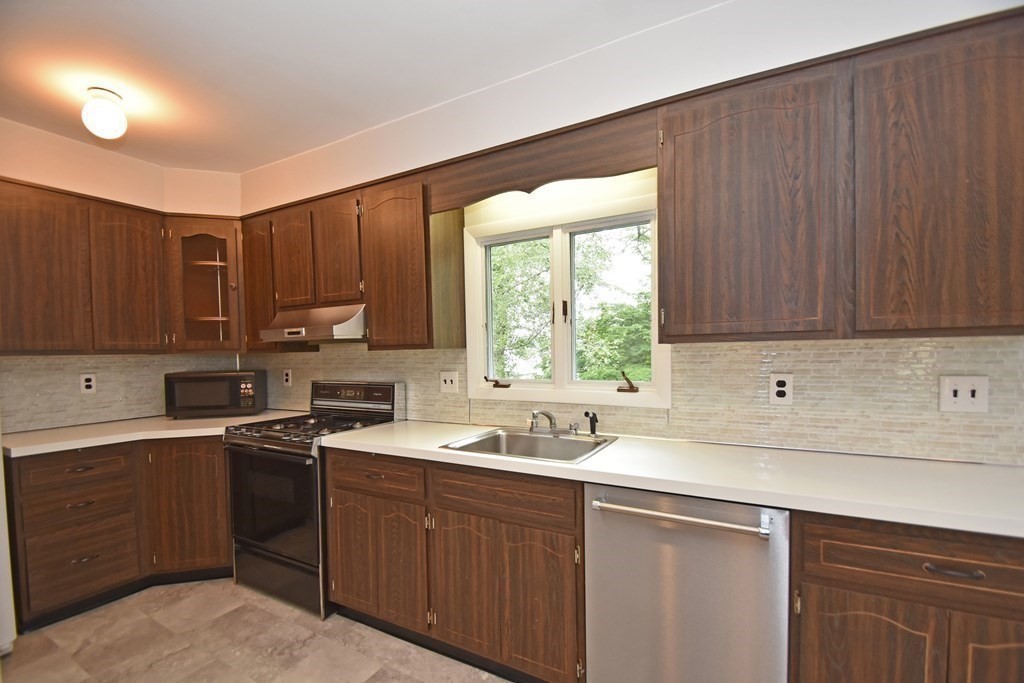 87 Standish Road Watertown, MA 02472 - Photo 8 of 27 a kitchen with a sink stove and cabinets