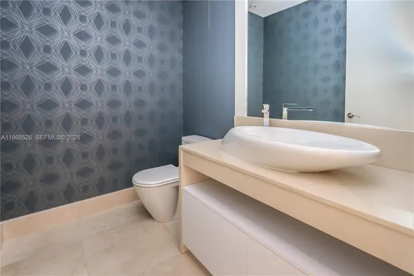 a bedroom with a bed lamp and a large window