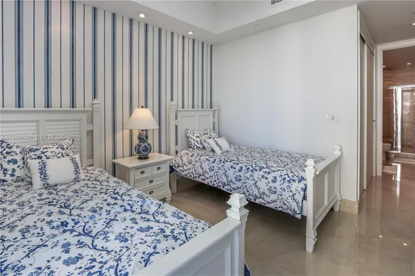 a bedroom with a large bed and a closet