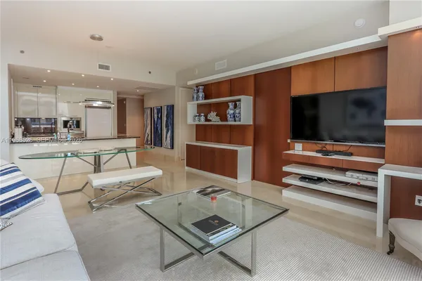 a living room with furniture and a floor to ceiling window
