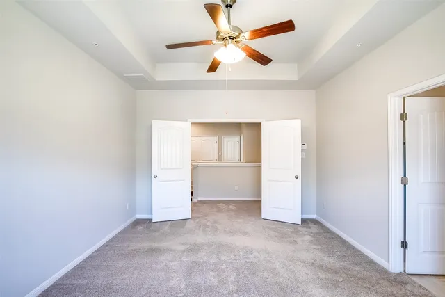 an empty room with a bathroom and a window