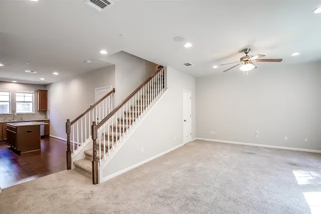 a view of a kitchen with a sink refrigerator and wooden floor