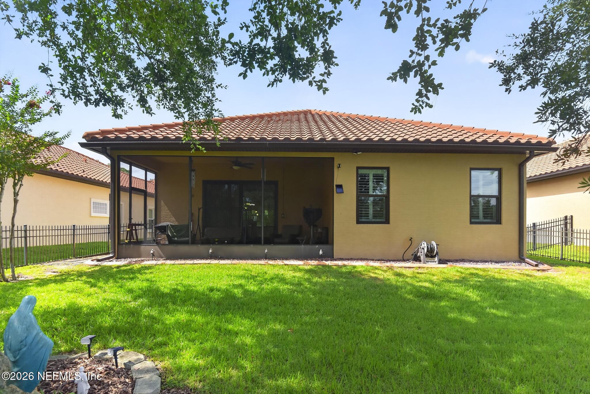 110 Vía Roma Ormond Beach, FL 32174 - Photo 36 of 43 a view of a house with a yard potted plants and a large tree