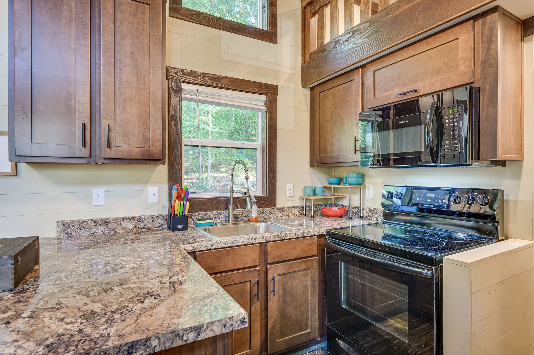 30 Oakleaf Trail Tracy City, TN 37387 - Photo 15 of 50 a kitchen with stainless steel appliances granite countertop wooden cabinets a stove a sink and a window