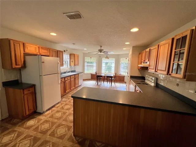 a kitchen with counter top space cabinets and stainless steel appliances