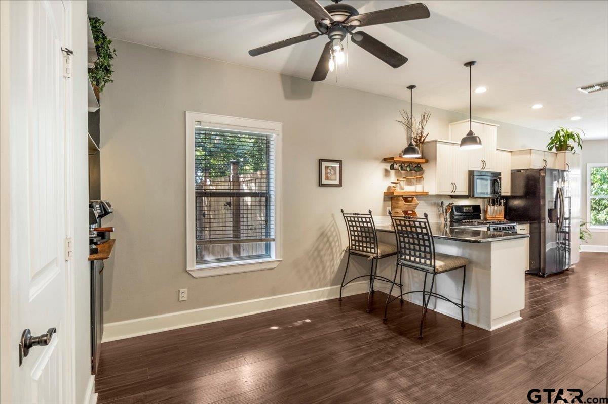 19577 Dove Ridge Lane Lindale, TX 75771 - Photo 11 of 42 a living room with couches and kitchen view with wooden floor