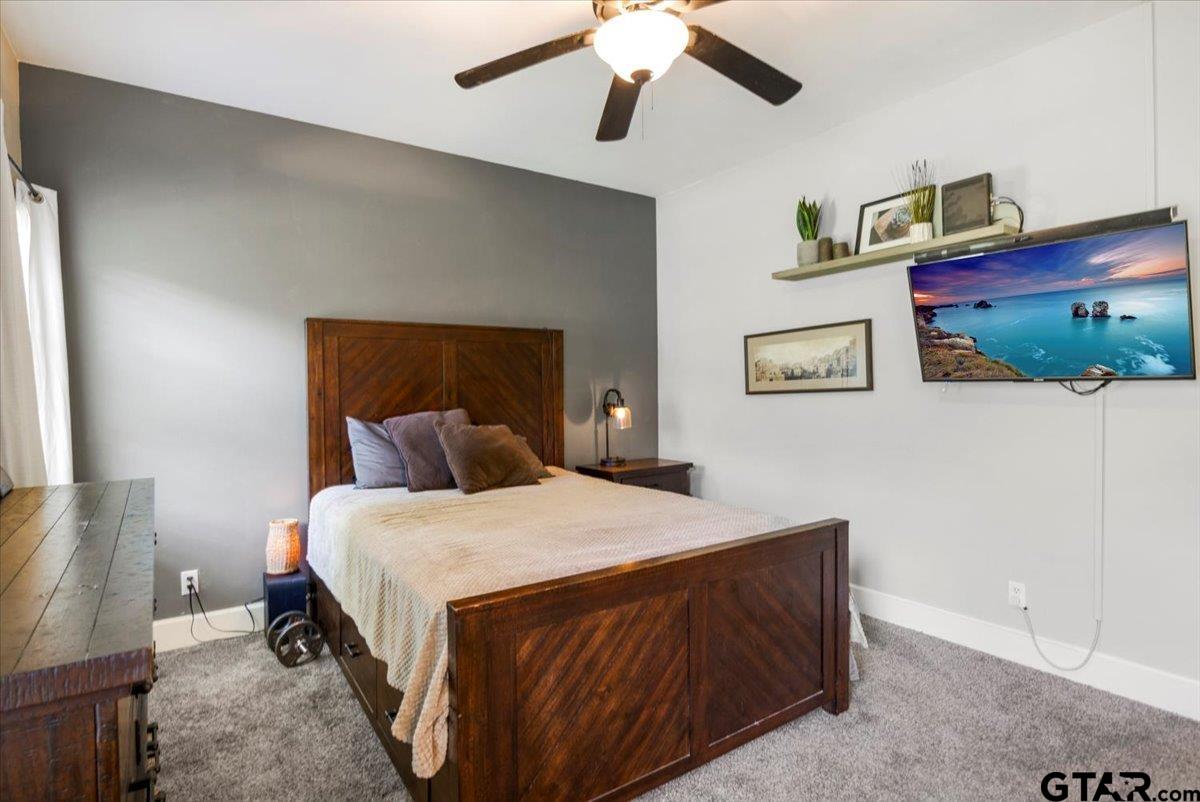 19577 Dove Ridge Lane Lindale, TX 75771 - Photo 14 of 42 a bedroom with a bed and a chandelier