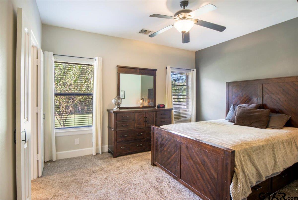 19577 Dove Ridge Lane Lindale, TX 75771 - Photo 15 of 42 a bedroom with a bed and a chandelier