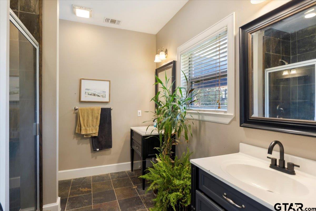 19577 Dove Ridge Lane Lindale, TX 75771 - Photo 17 of 42 a bathroom with a sink a mirror and shower