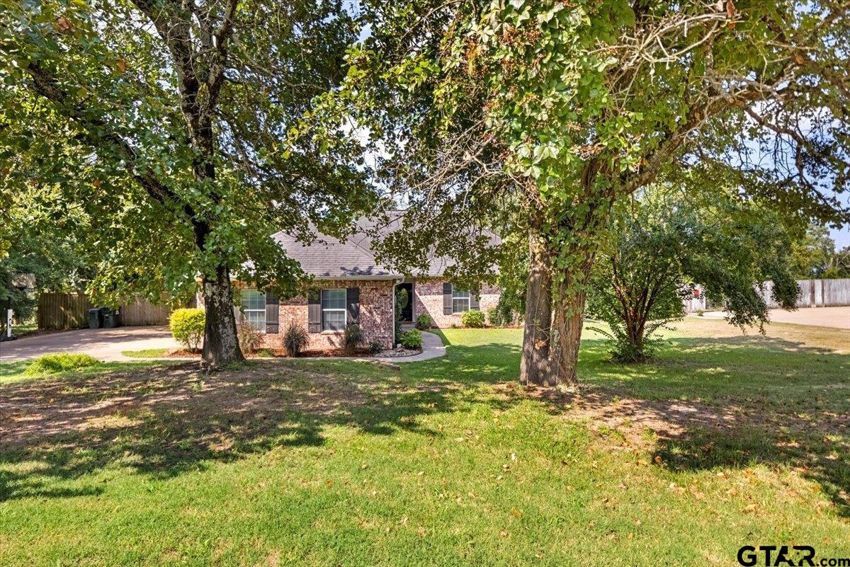 19577 Dove Ridge Lane Lindale, TX 75771 - Photo 2 of 42 a view of a tree in front of a white house