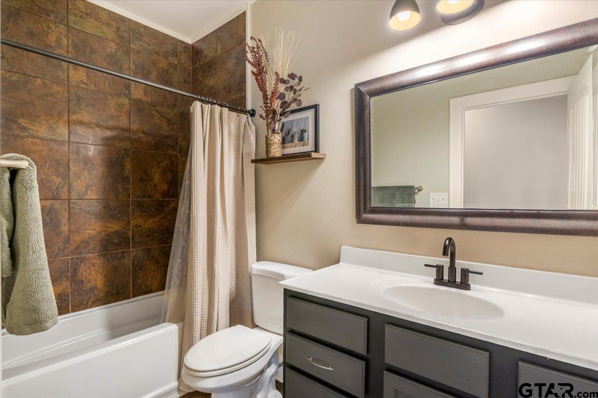 19577 Dove Ridge Lane Lindale, TX 75771 - Photo 21 of 42 a bathroom with a sink a toilet and shower