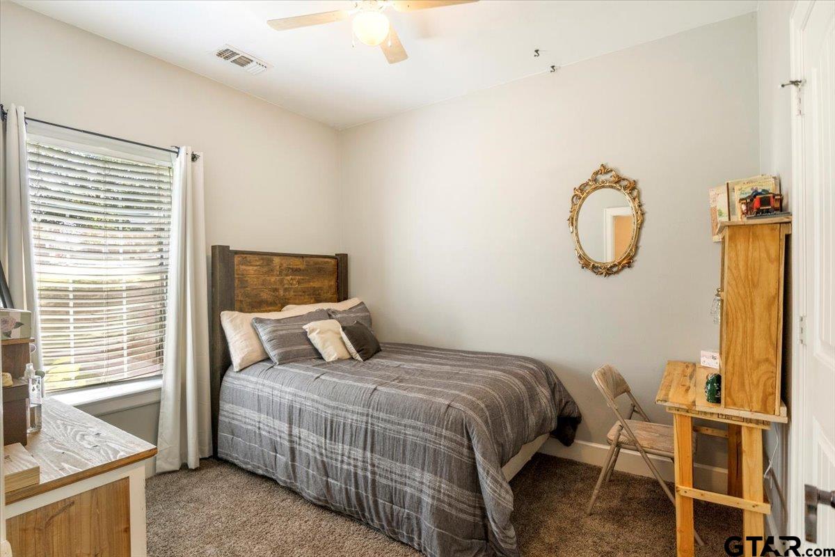 19577 Dove Ridge Lane Lindale, TX 75771 - Photo 24 of 42 a bedroom with a bed and wooden floor