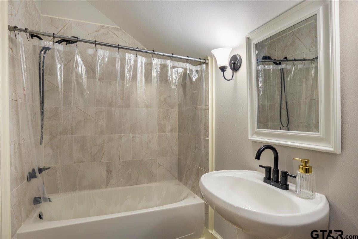 19577 Dove Ridge Lane Lindale, TX 75771 - Photo 28 of 42 a bathroom with a sink and a mirror