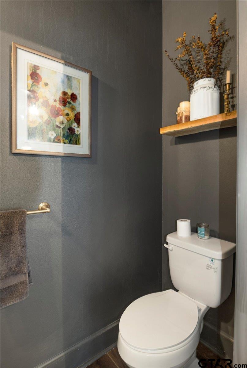 19577 Dove Ridge Lane Lindale, TX 75771 - Photo 29 of 42 a white toilet sitting next to a bathroom sink
