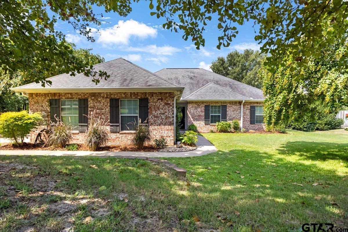19577 Dove Ridge Lane Lindale, TX 75771 - Photo 3 of 42 a front view of a house with garden and porch