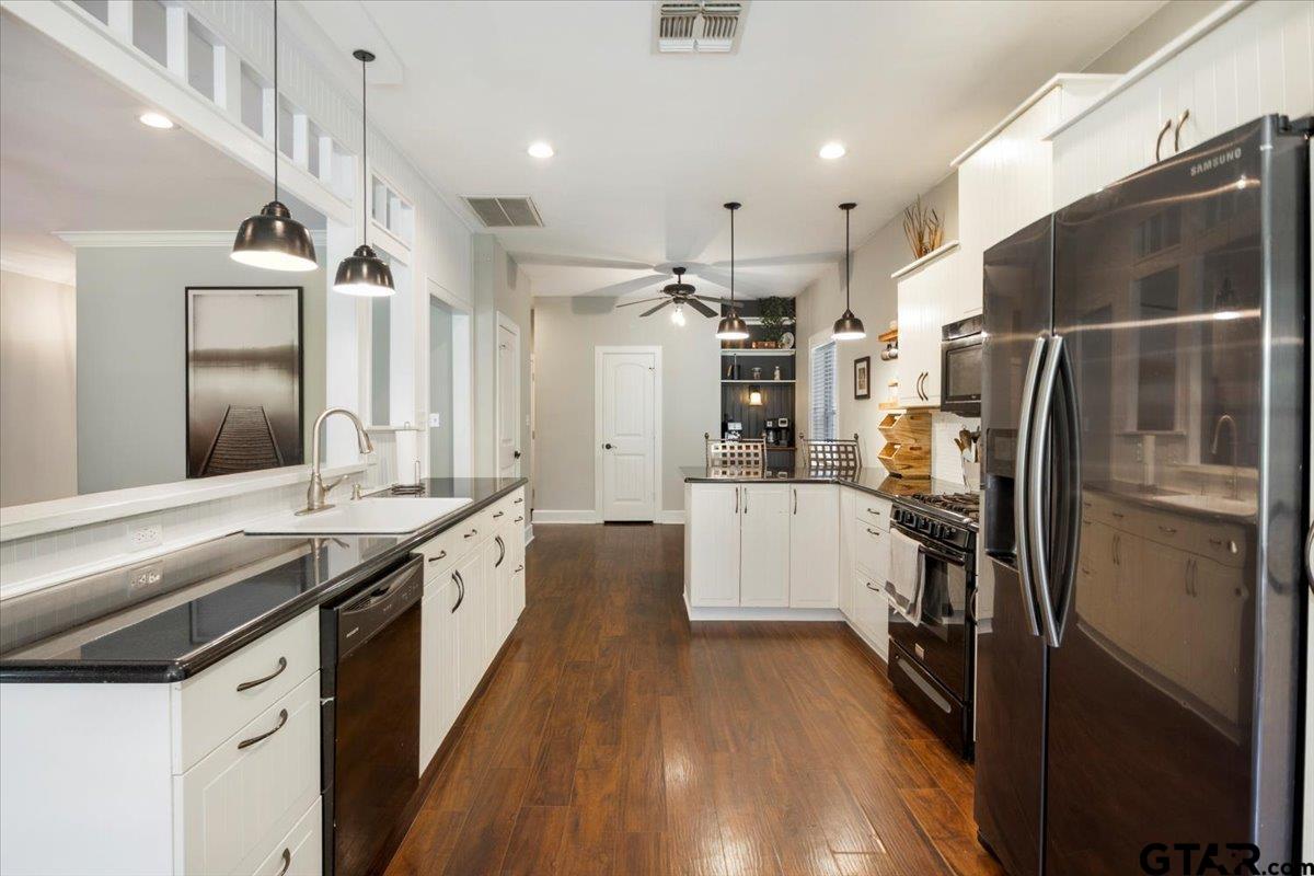 19577 Dove Ridge Lane Lindale, TX 75771 - Photo 9 of 42 a modern kitchen with stainless steel appliances a refrigerator and a stove